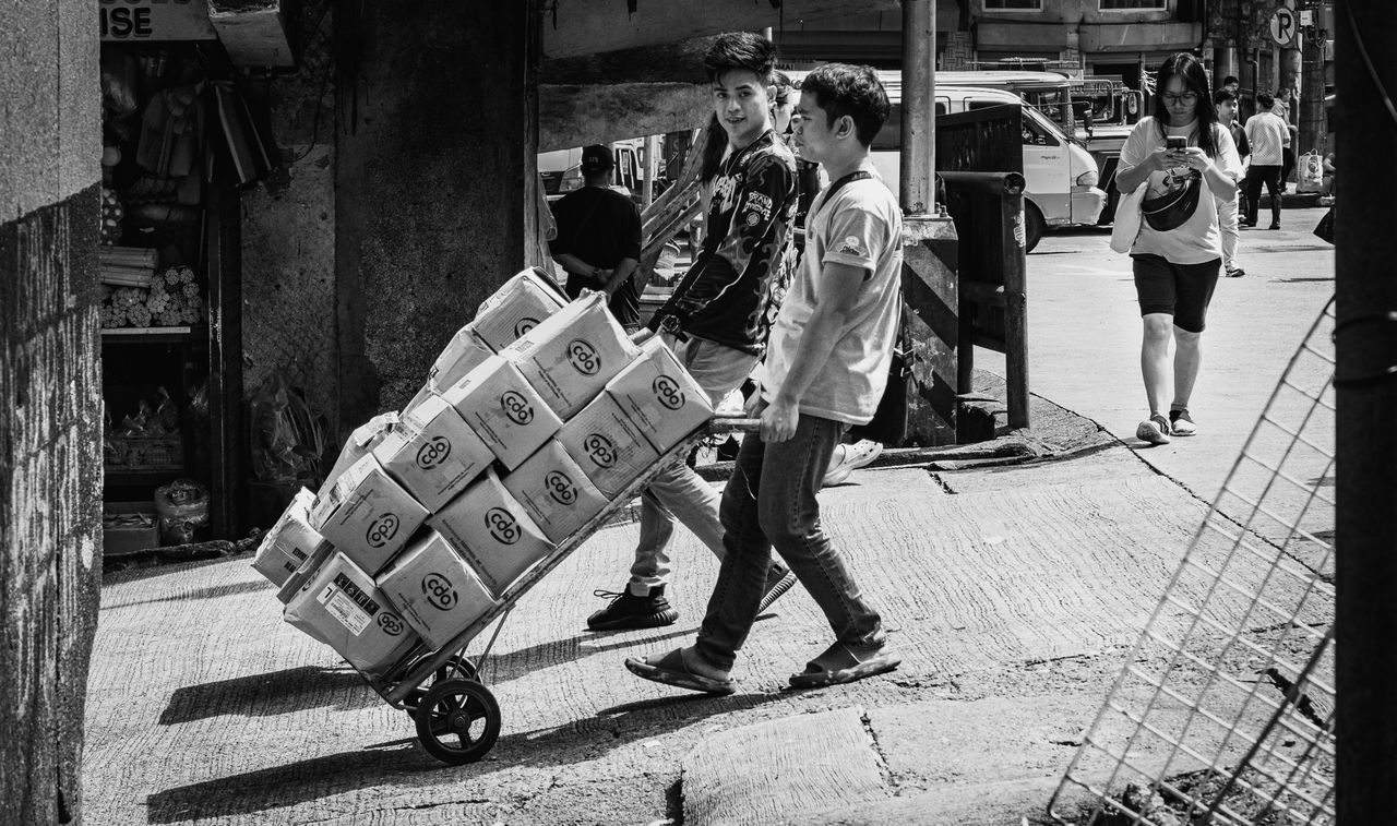 Monochrome image capturing daily life in Baguio City market scene.